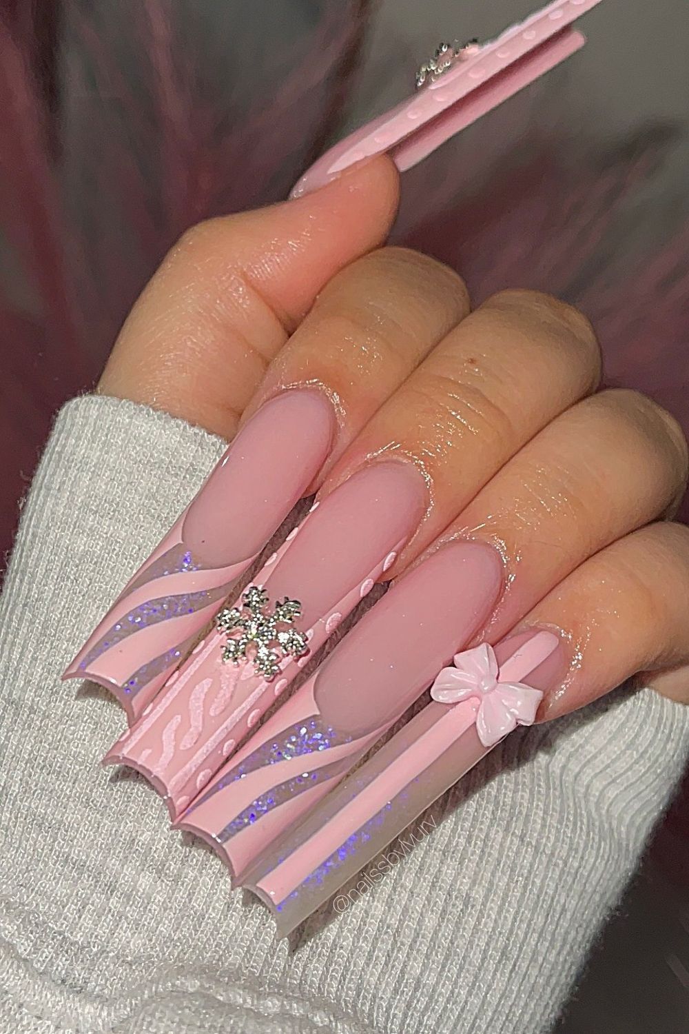 Pink bow snowflake nails 2025 design. Want more pink nail inspo? Click here!