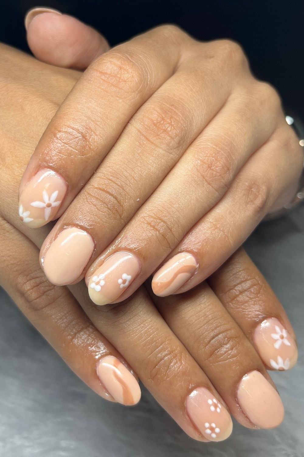 Peach nude summer nails with white flowers and wave designs for 2025
