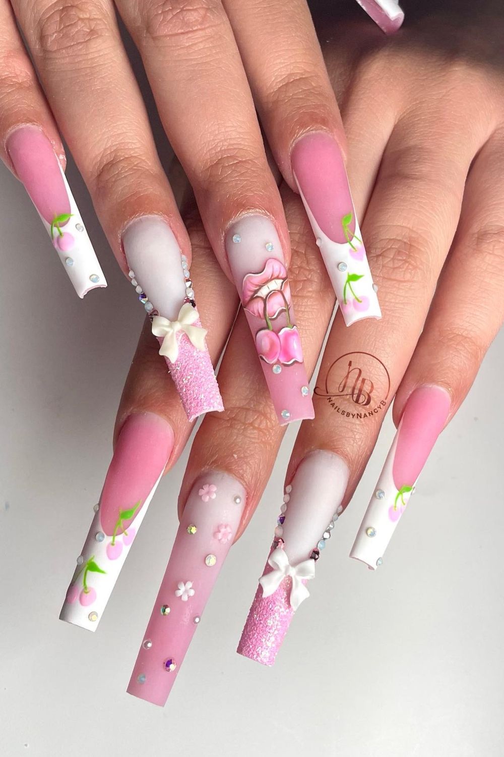 Dreamy pink bow cherry nails? Discover chic pink nail art for a trendy 2025 style!