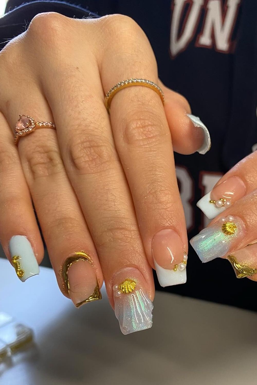 Looking for amazing summer nail ideas for 2025? See this stunning beach mermaid nail design with seashells and pearls! Find more perfect summer nails for every skin tone in our collection.