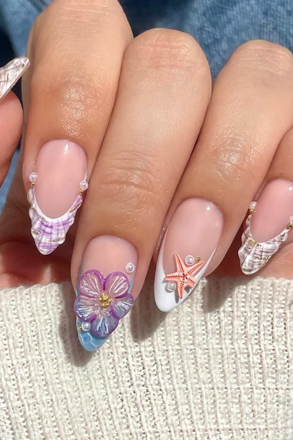 Are you looking for amazing summer nails for 2025? Check out this cute beach design with a flower, starfish, and shell! Get inspired for your next manicure.