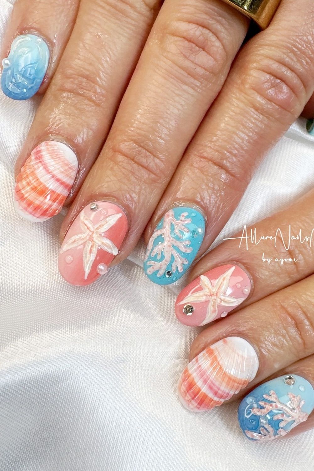 Need fresh summer nail ideas for 2025? See this pretty beach look with seashells and starfish! Explore 43 stunning summer nails perfect for your skin tone.