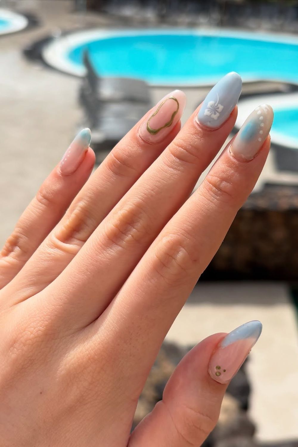 Looking for summer nails 2025 ideas? See our collection of nail designs perfect for every skin tone, like this blue and pink flower style!