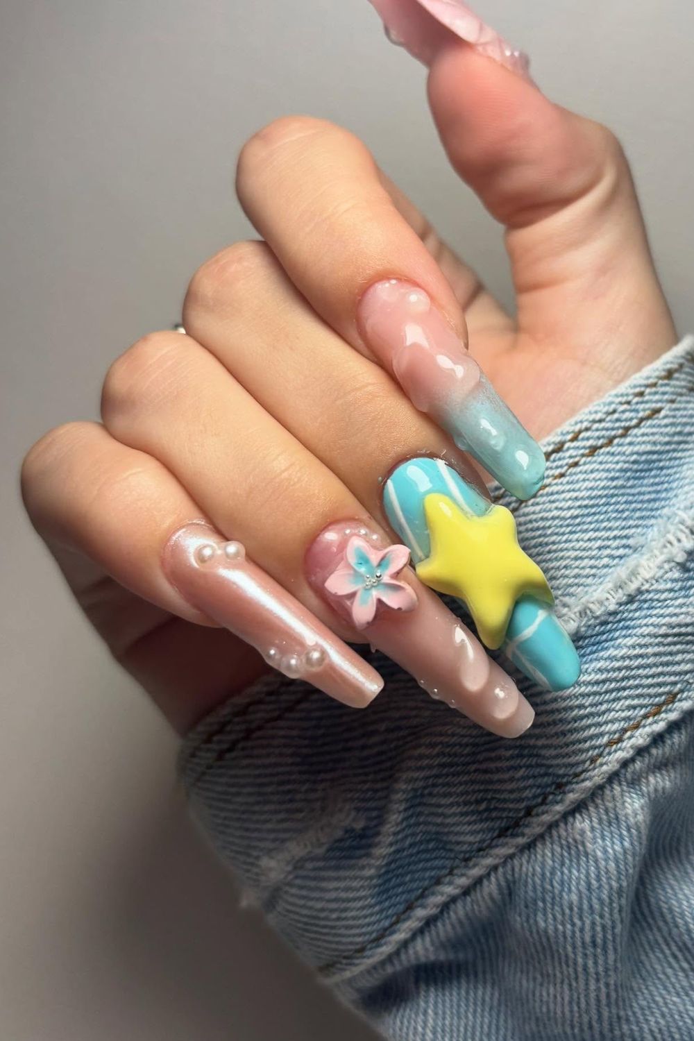 Looking for amazing summer nails for 2025? See these fun pink, blue, and yellow designs with stars, flowers, and pearls!