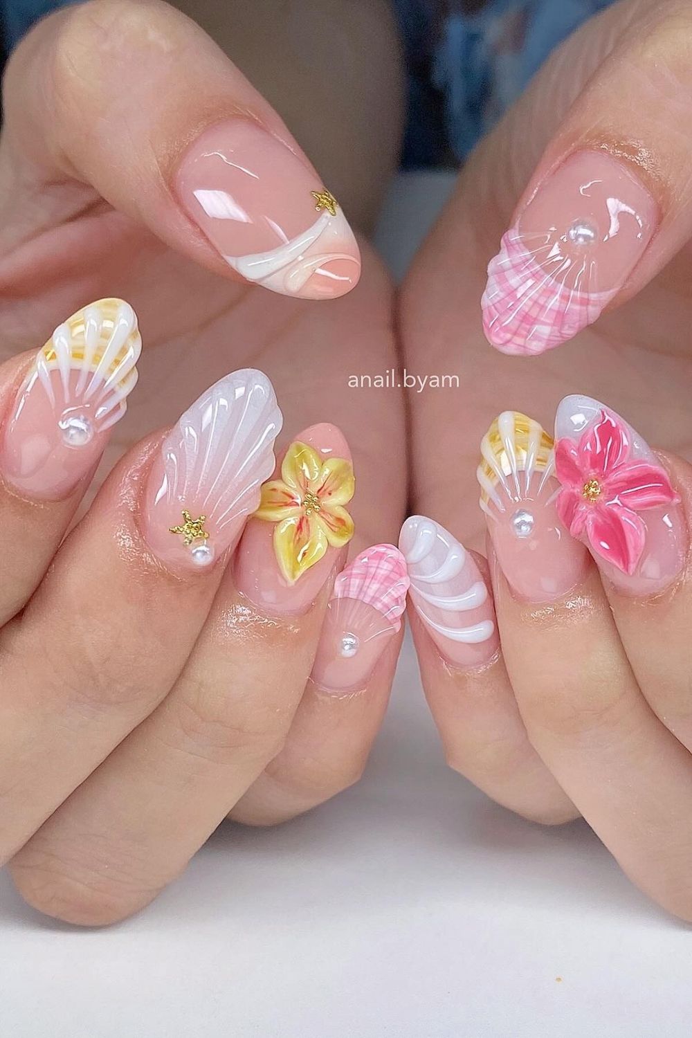 This picture shows adorable 3D summer nails with seashells and flowers. Want to see 43 amazing summer nail ideas for 2025? Our list has perfect designs for every skin tone! Find your dream summer manicure now.