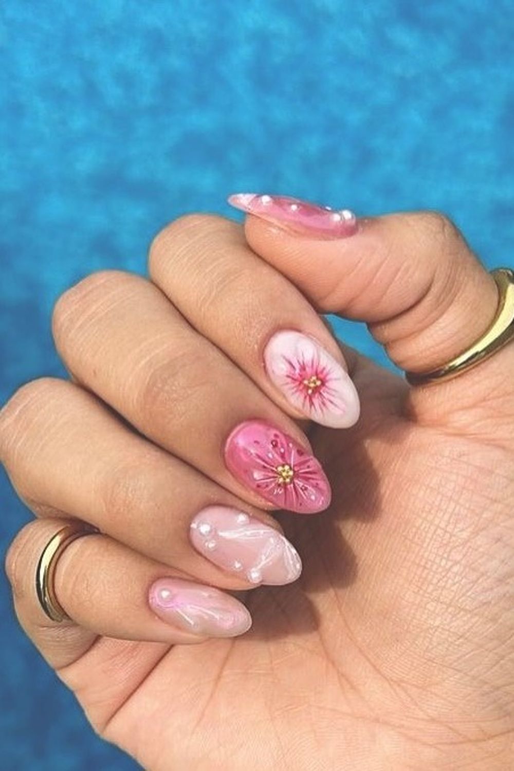 Looking for beautiful summer nail ideas for 2025? See this stunning pink flower and pearl nail design perfect for any skin tone!