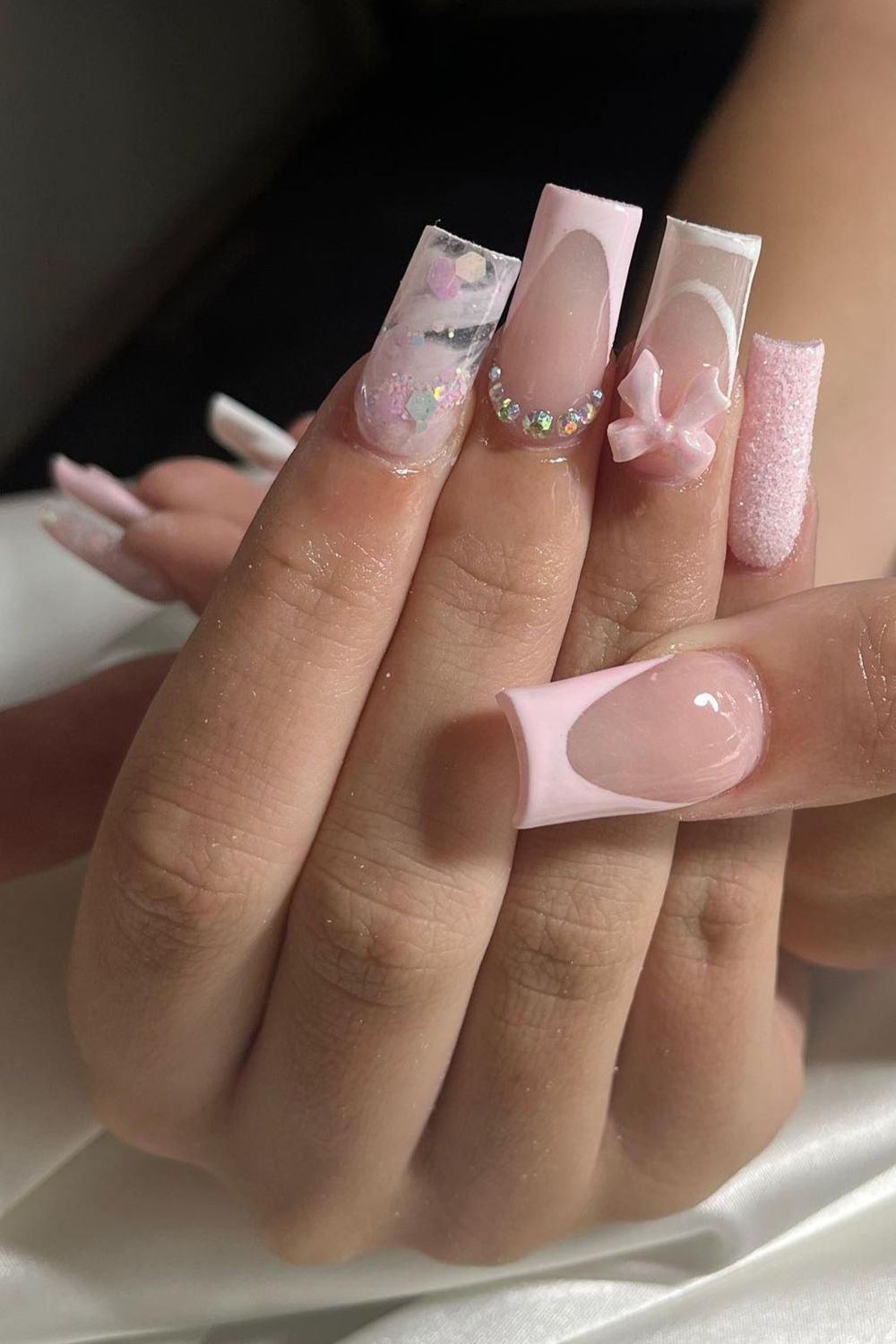 Dreaming of luxury pink nails? Explore these opulent pink square nails with white bows and glitter accents for a chic 2025 look!