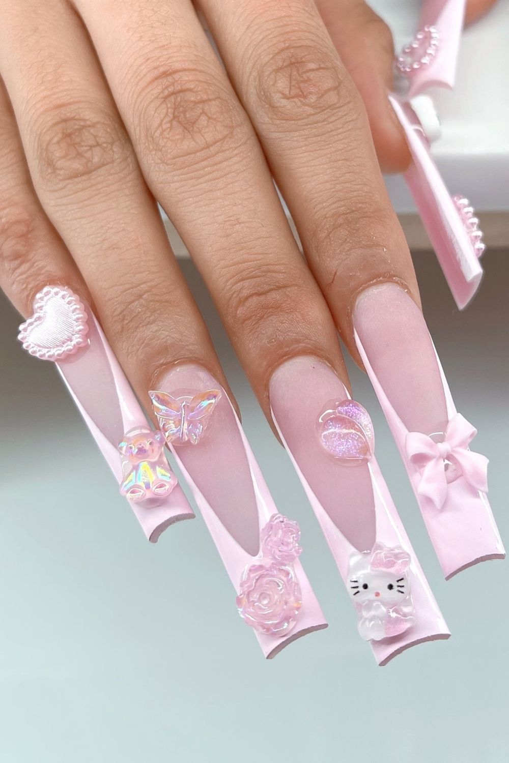 Want cute pink nails? See these pink nails with bows, teddy bear, and charms for 2025!
