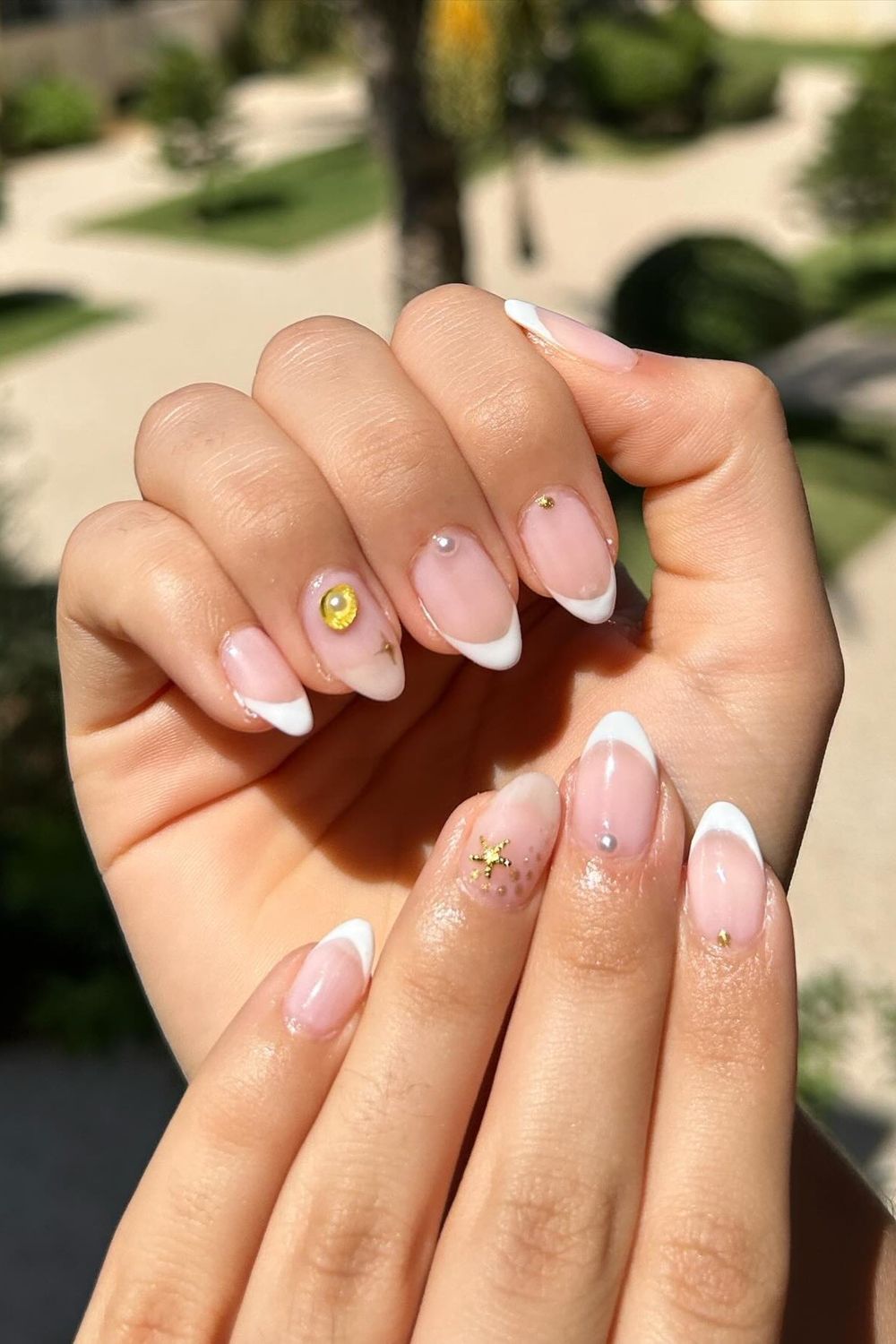 Need fresh summer nail ideas for 2025? Get inspired! See this elegant French manicure with gold stars and pearls and lots more looks perfect for you.
