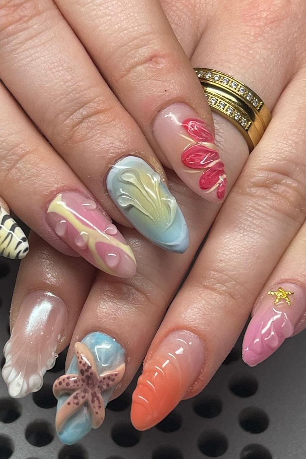 Colorful 3D summer beach nails 2025 with starfish, seashells, and water drops. Perfect ocean themed nail art ideas.